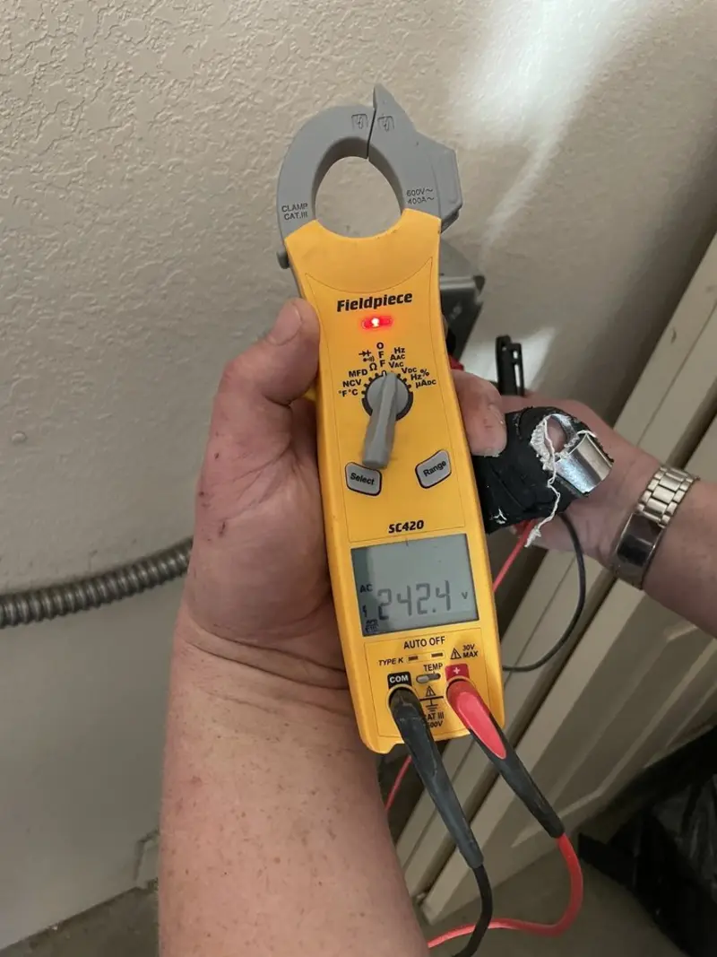 Voltage testing with clamp meter during Ceiling Fan Installation in Freeport